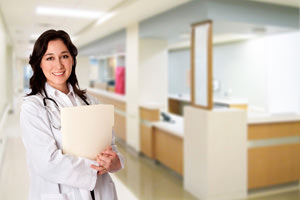 Smiling physician holding patient files.